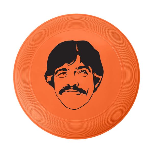 Orange frisbee featuring a black silhouette of a man’s face design